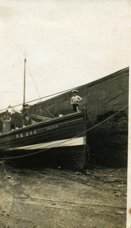 Small Boy standing on a Fishing Boat