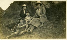 Two women with two young boys and a dog