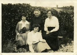 Four women in garden.  Possible family group.