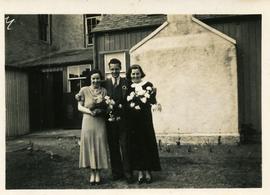 Two women and man, possibly wedding photograph.