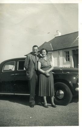 Couple Standing Beside Their Car